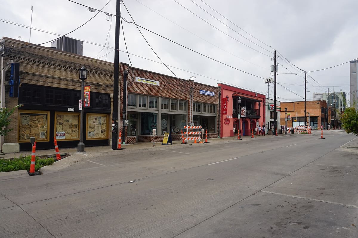 Brick one-story and two-story storefronts along Elm Street in Deep Ellum, Dallas