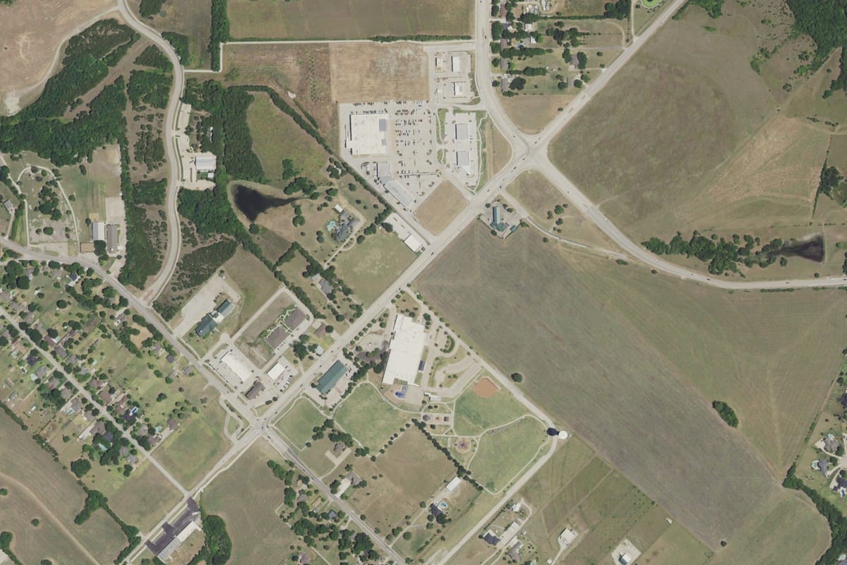 2022 aerial view of Heath's commercial core, with the Tom Thumb center at the FM 740 and FM 549 junction, Amy Parks-Heath Elementary and Towne Center Park below it, and open pasture to the east