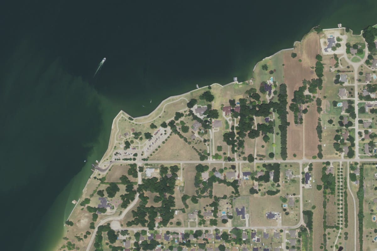 2022 aerial view of Terry Park in Heath, Texas, a grassy point on Lake Ray Hubbard with a parking lot, a looping walking path, and a boat ramp at the end of Terry Lane