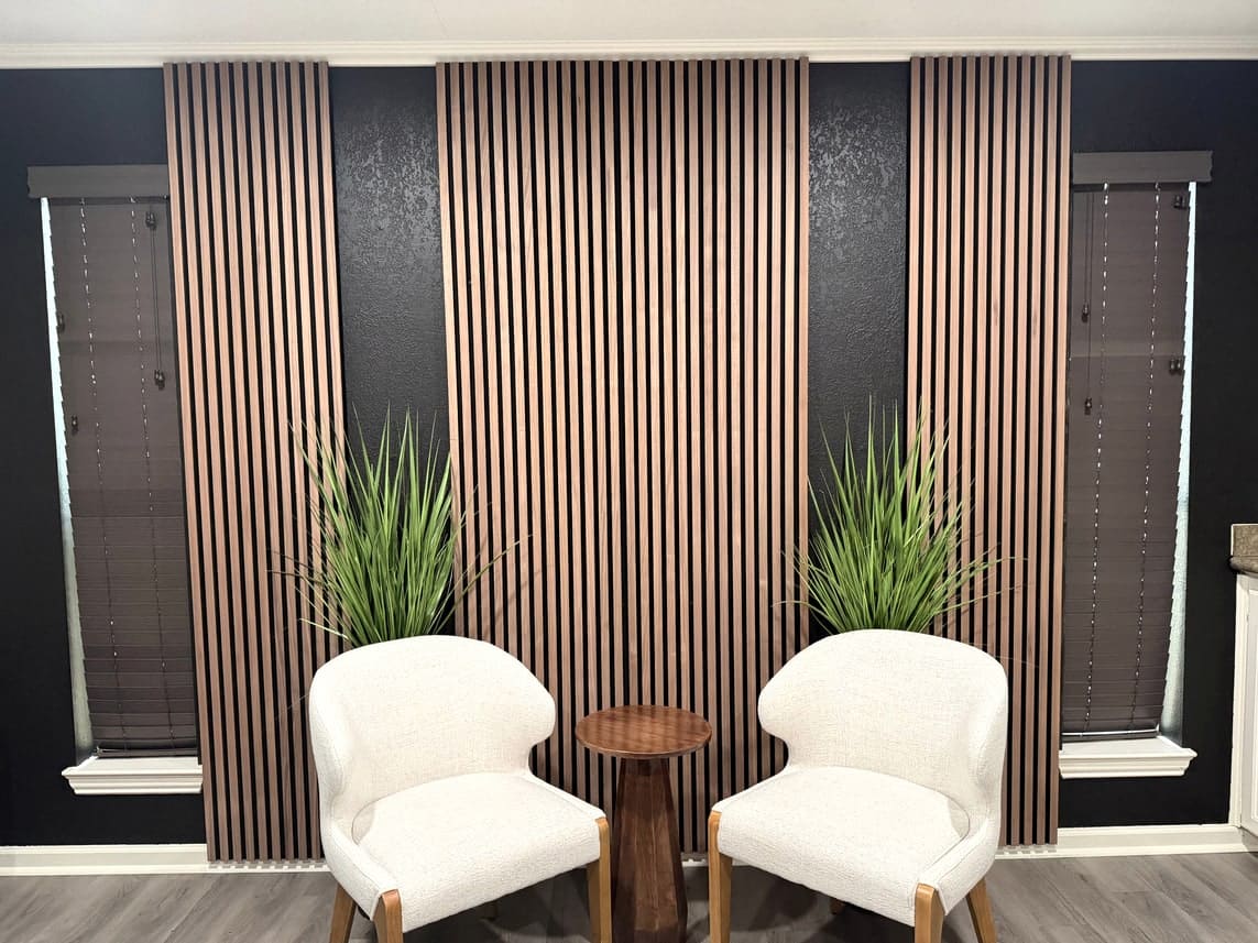 Consultation nook with wood slat wall and acoustic treatment.